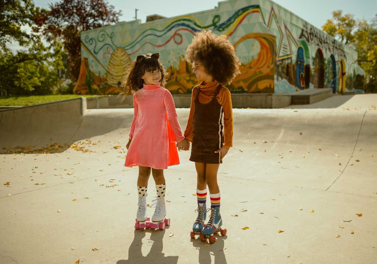 Lifestyle image of rainbow baby tube socks with playful outfit