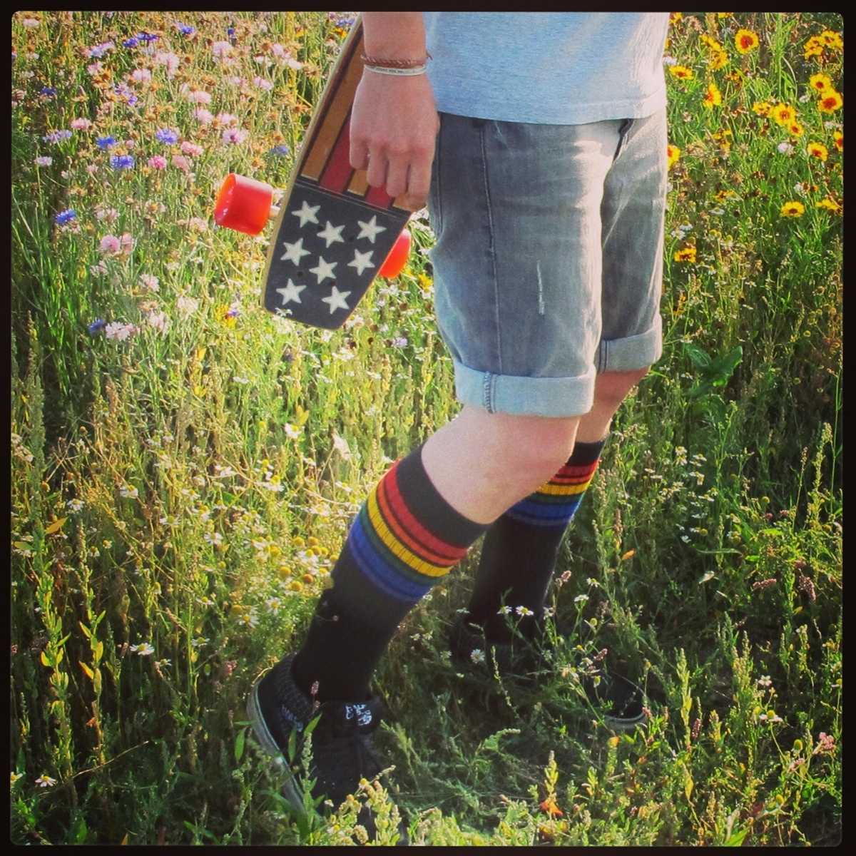 Close-up of Brave rainbow knee high tube socks by Pride Socks