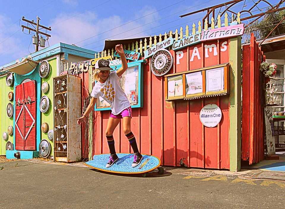 Lifestyle image of Strength rainbow striped tube socks while on the skateboard