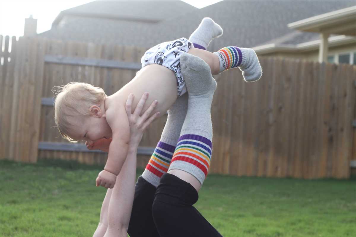 Cheerful toddler wearing bold rainbow socks with sneakers