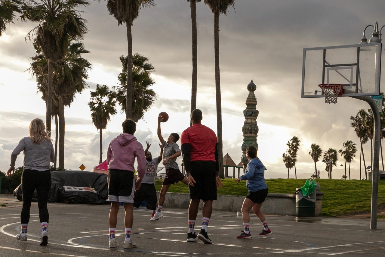 jason collins from the nba wearing his pride socks while playing basketball