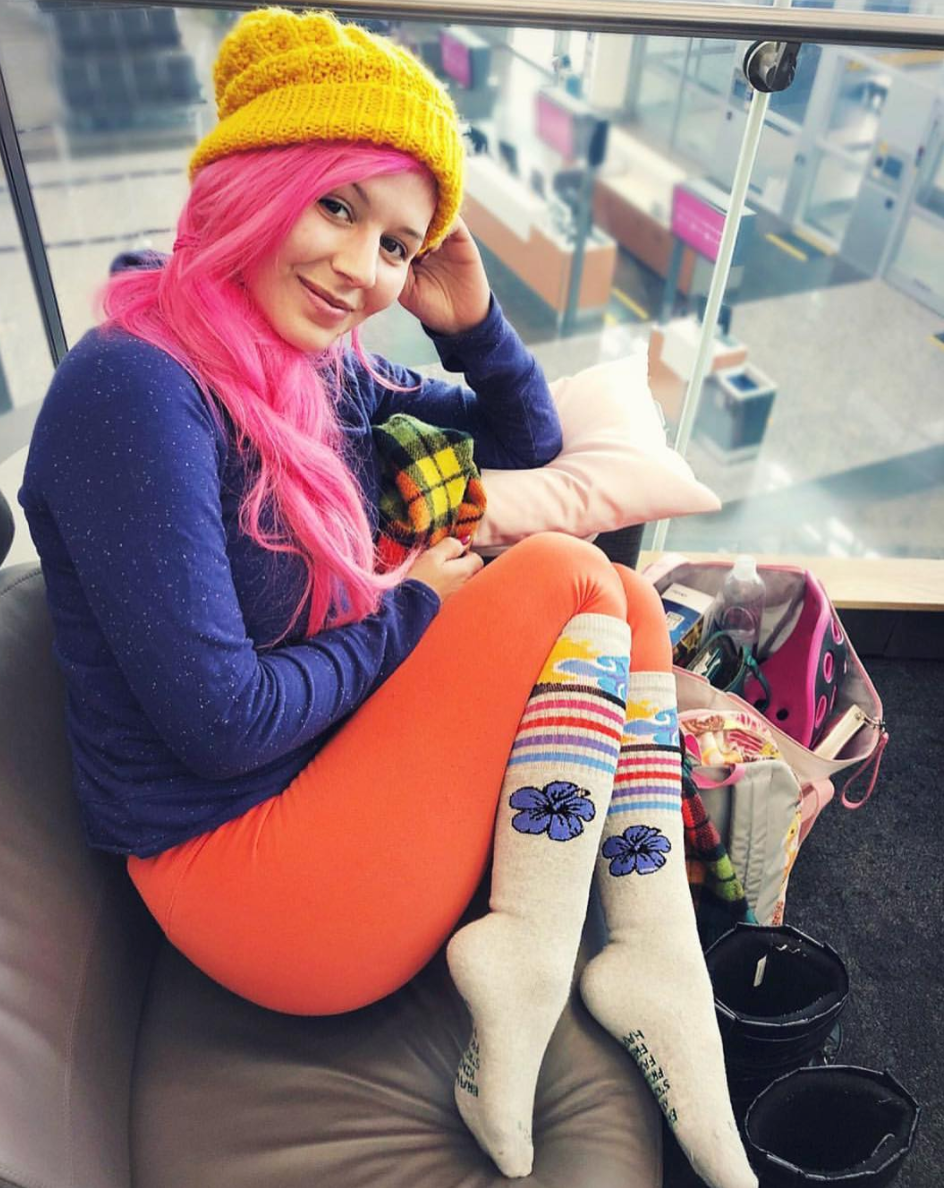 Annalee Belle loving her sky brown pride socks while having a layover in Vegas.
