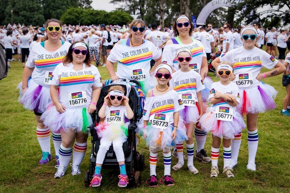 Person wearing Courage rainbow socks at outdoor event called the color run as a group all wearing pride socks