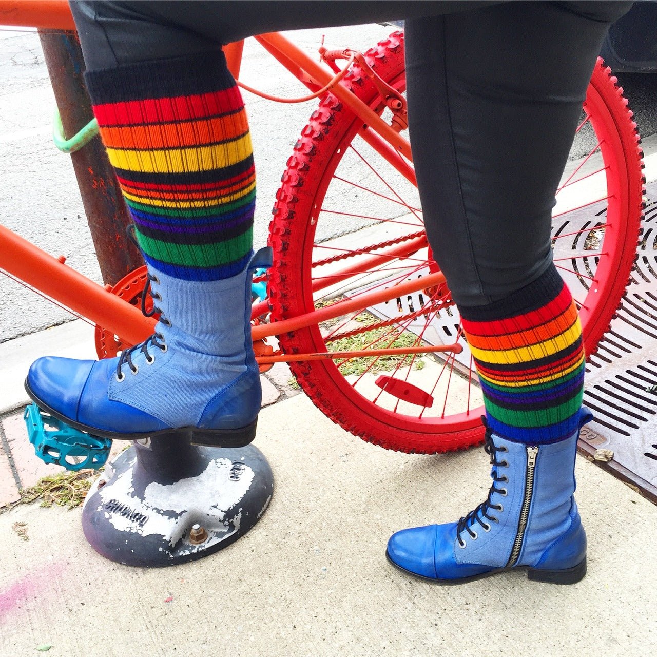 Power rainbow knee high tube socks with colorful rainbow stripe pattern on the bike
