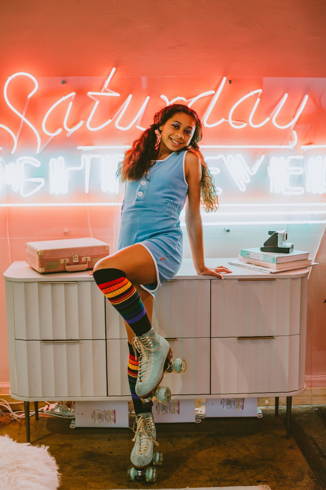 Person wearing Power rainbow socks modeling the socks while wearing pride socks