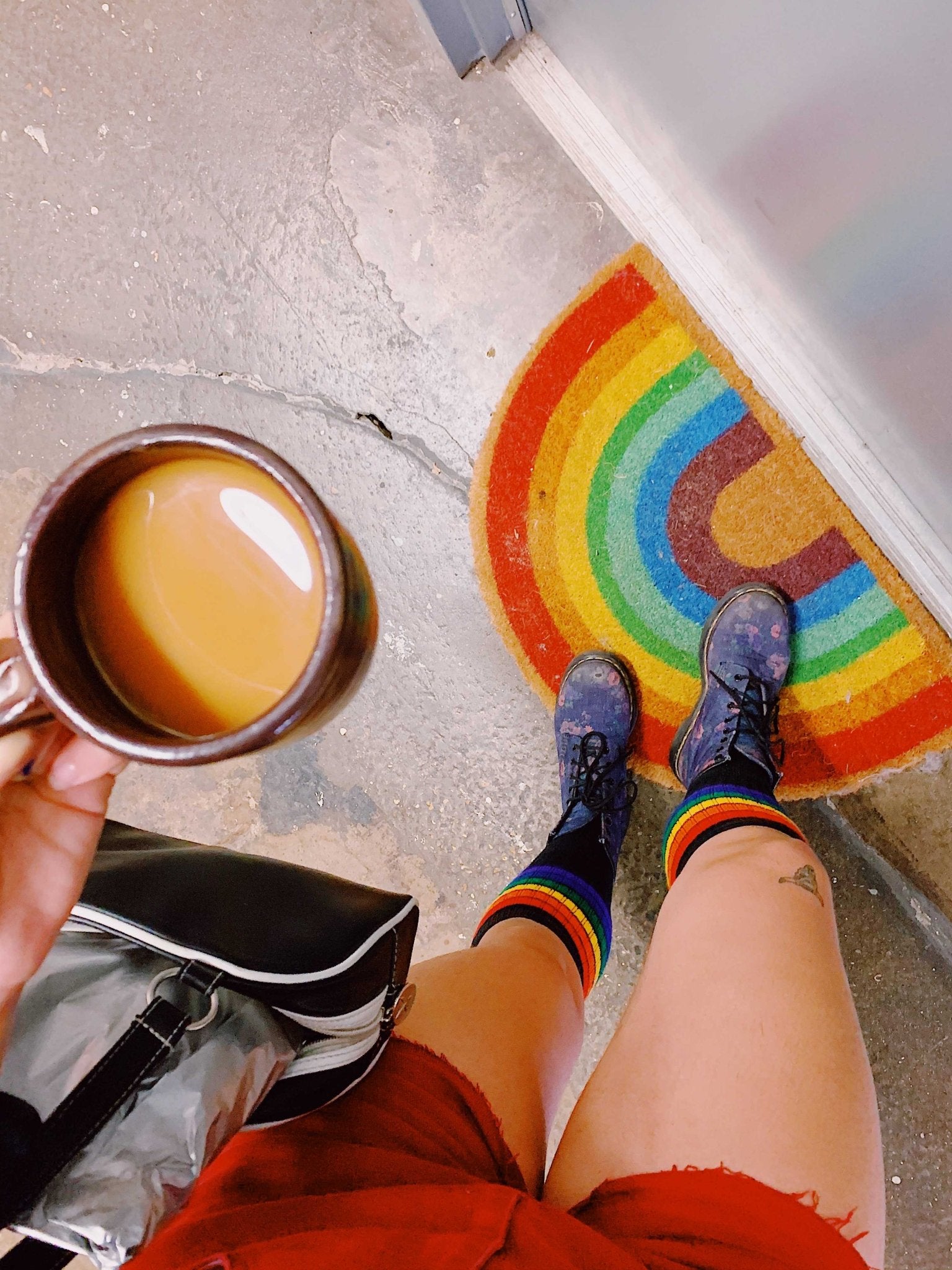 Brave rainbow tube socks styled with roller skates and pride apparel