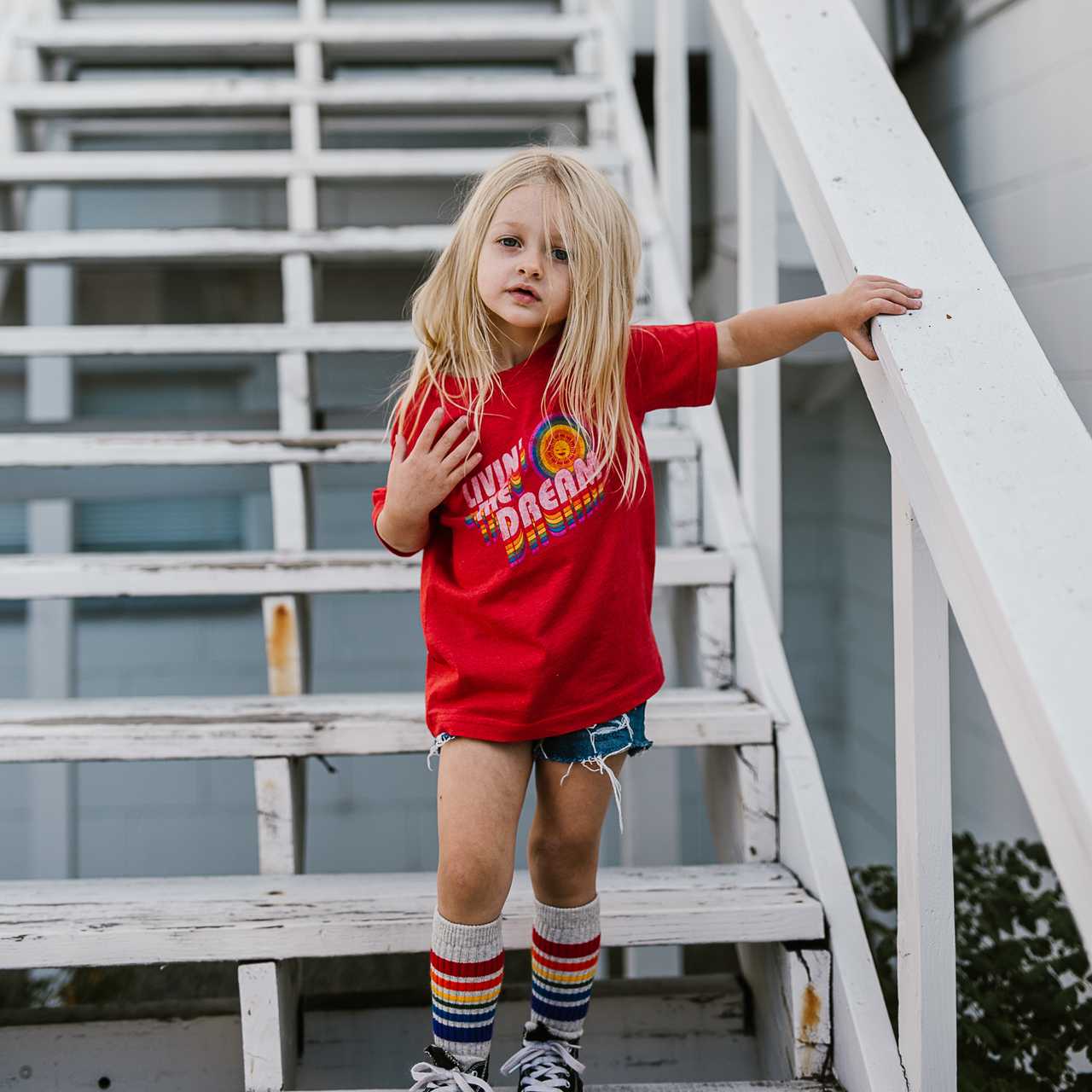 Toddler wearing rainbow socks and expressing their colorful personality