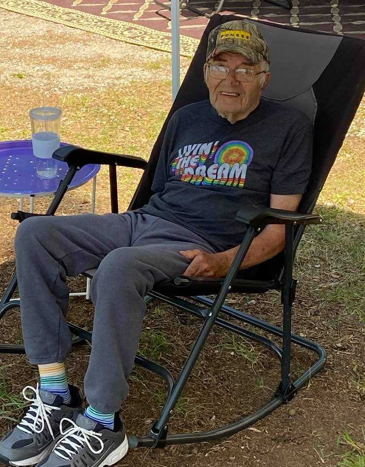 our oldest customer is 90 rocking his pride socks living the dream shirt while camping outside.