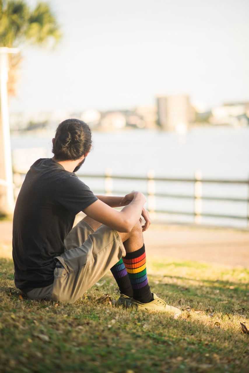 Person wearing Glow rainbow socks at festival and outdoor event