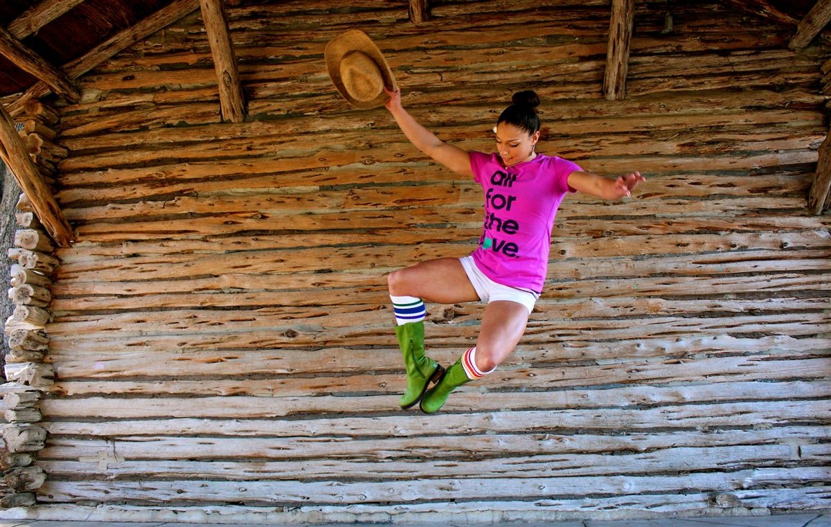 Courage rainbow knee high socks styled with fashion forward green cowgirl boots