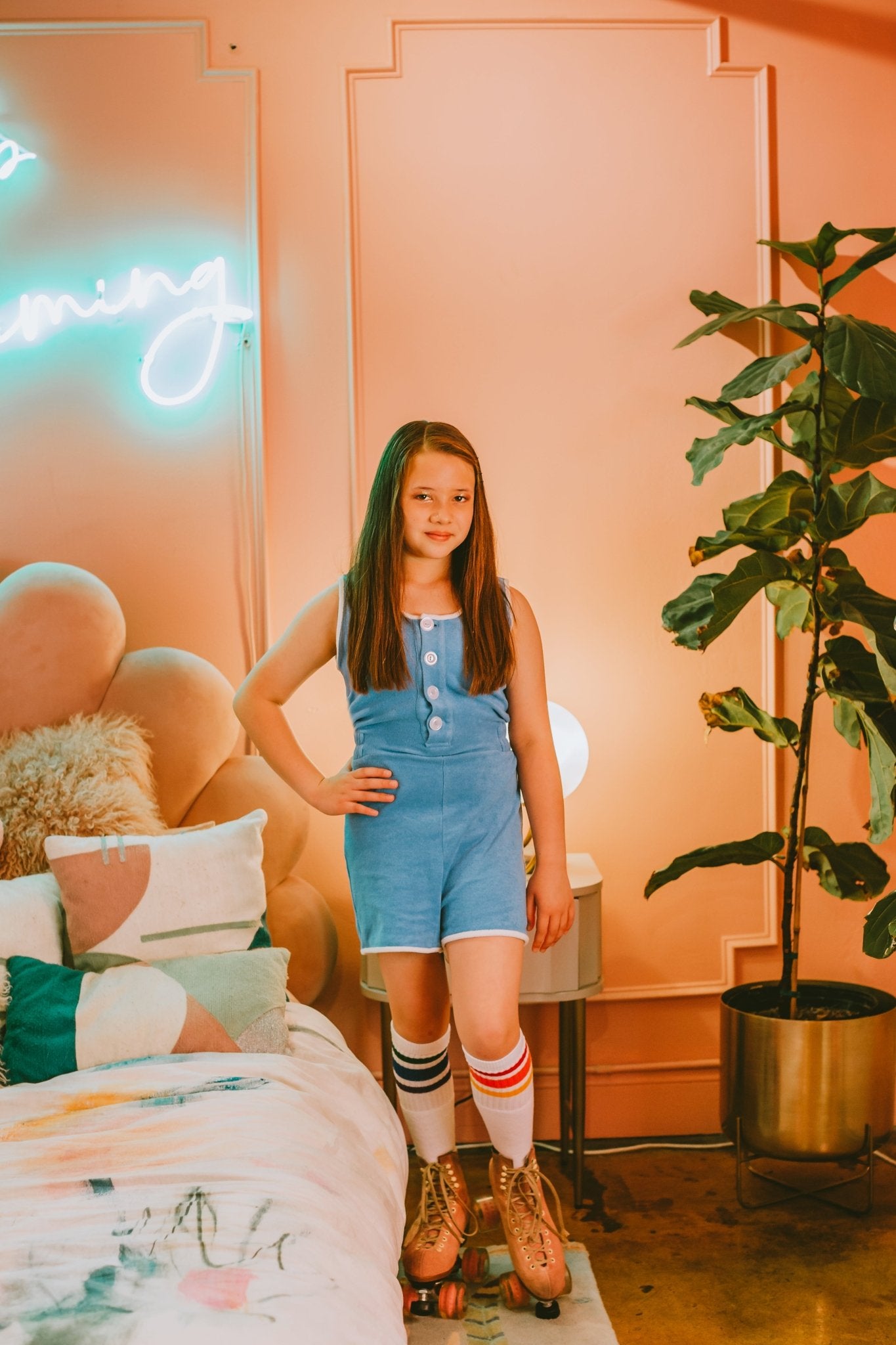 Lifestyle image of Courage rainbow tube socks with pride outfit and roller skates
