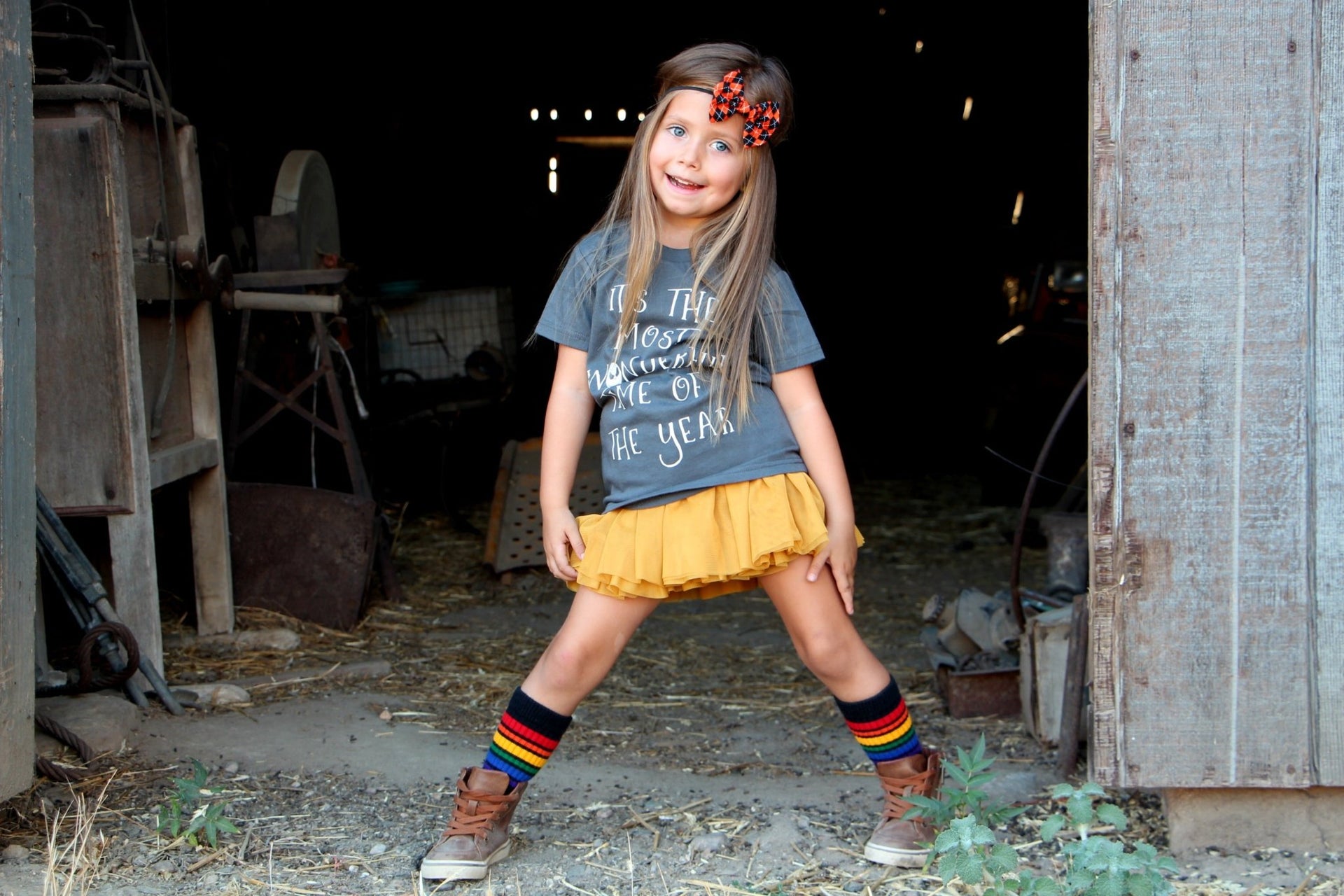 Brave rainbow striped socks styled with casual outfit playing with the farm animals