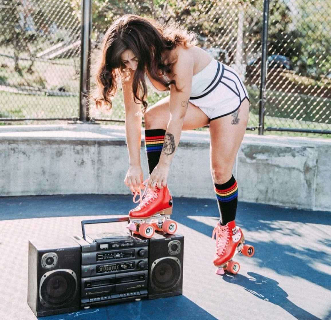 LGBTQ+ athletic wear featuring retro rainbow knee-high socks