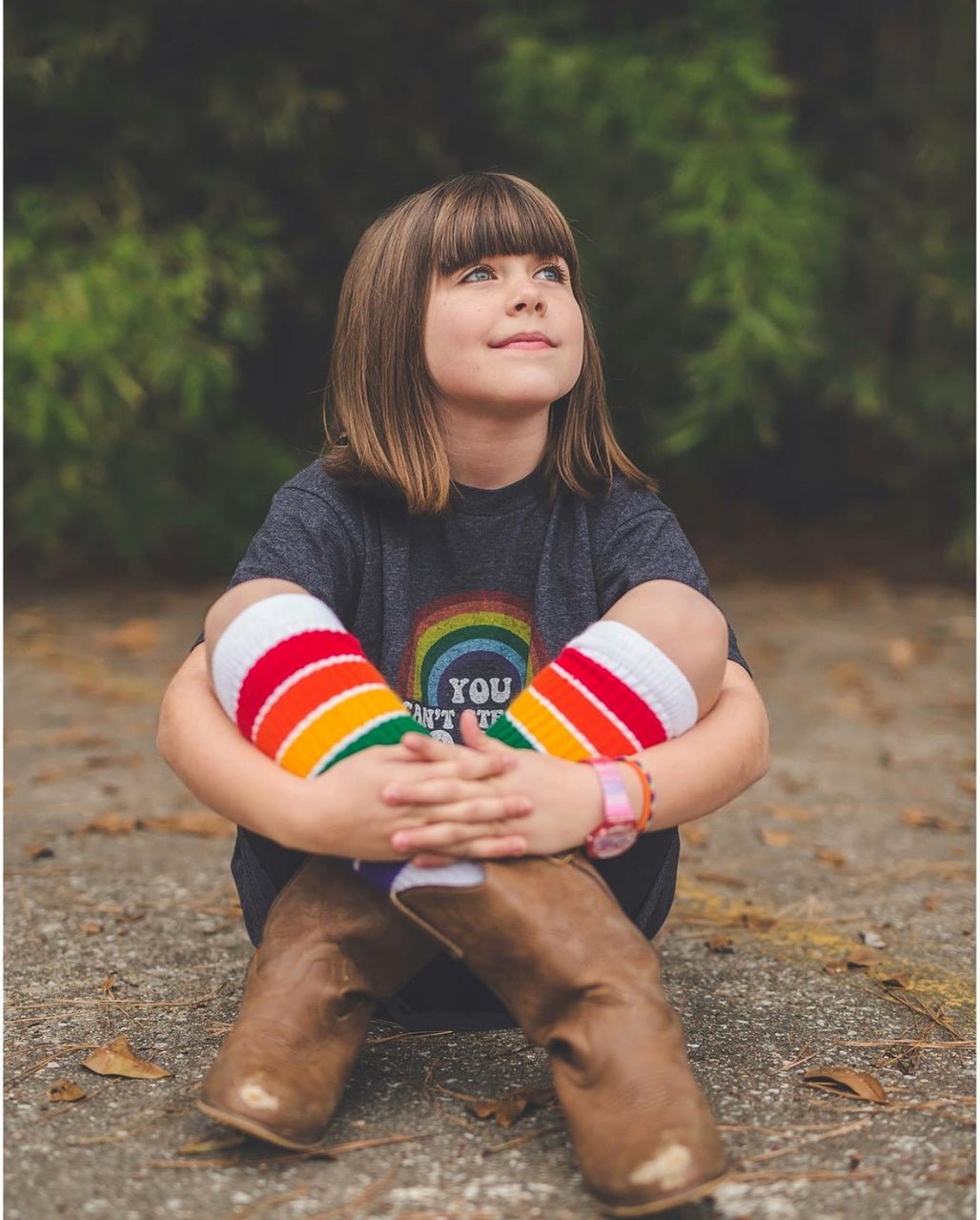 Close-up of YOLO rainbow knee high tube socks by Pride Socks