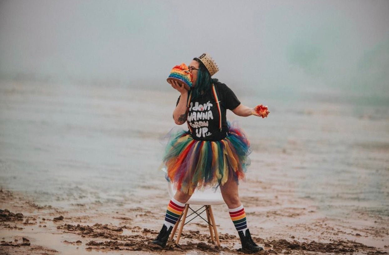 YOLO rainbow socks styled with roller skates and pride apparel eating a rainbow birthday cake