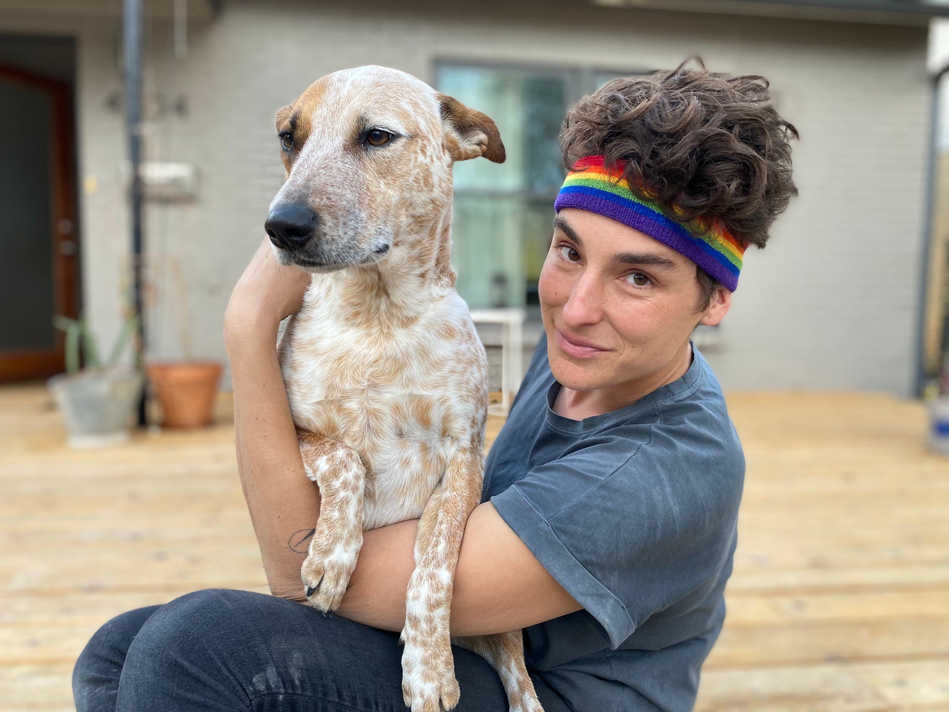 rainbow headband and wristbands at pride festival  at home with dog.